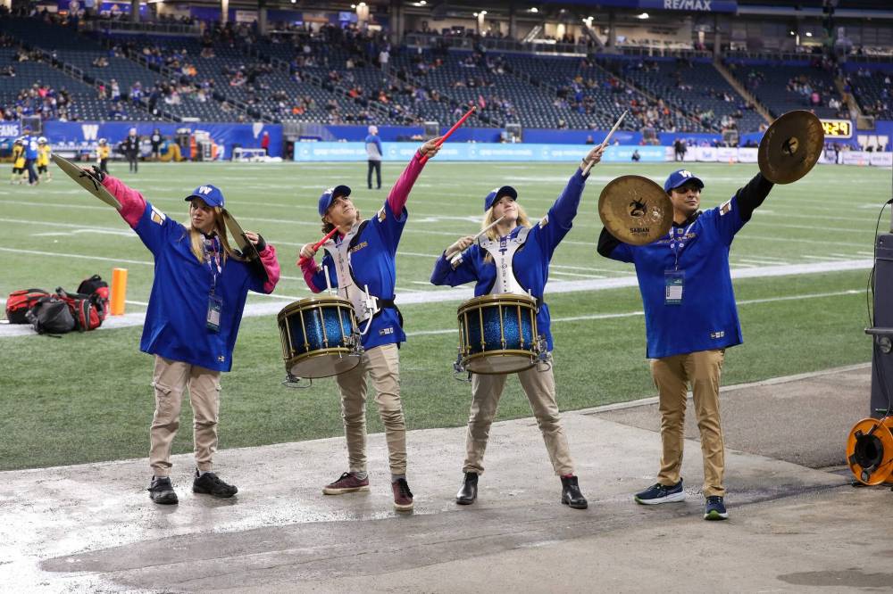 Drumline members Terri Erdmann (from left), 22, Jaremy Ediger, 36, Kaitlyn Childs, 23, and David Moncayo, 23, get the crowd going during a game against the visiting Saskatchewan Roughriders last week. (Brook Jones / Free Press)