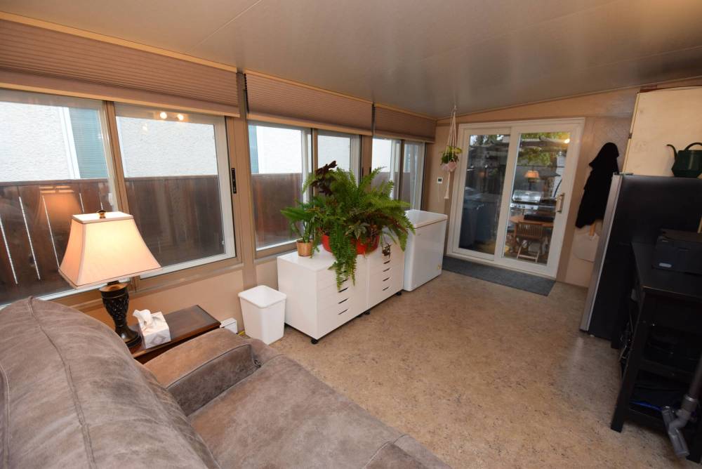 TODD LEWYS / FREE PRESS
                                The insulated sunroom has a wall of windows and patio door leading to the backyard.