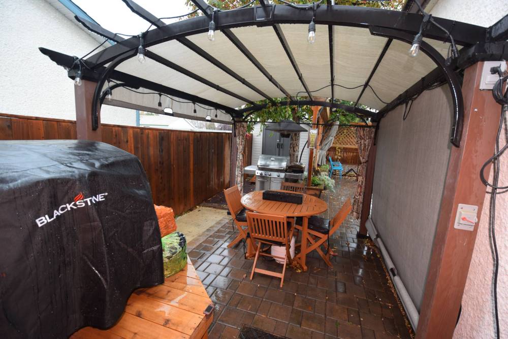TODD LEWYS / FREE PRESS
                                The fabulous backyard starts off with a pergola area and patio and branches out into another patio plus a firepit, cat run and shed.