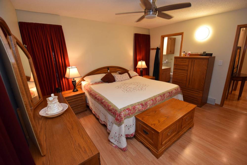 TODD LEWYS / FREE PRESS
                                Nestled away neatly in its own private corner of the home, the spacious primary bedroom is a true sanctuary.