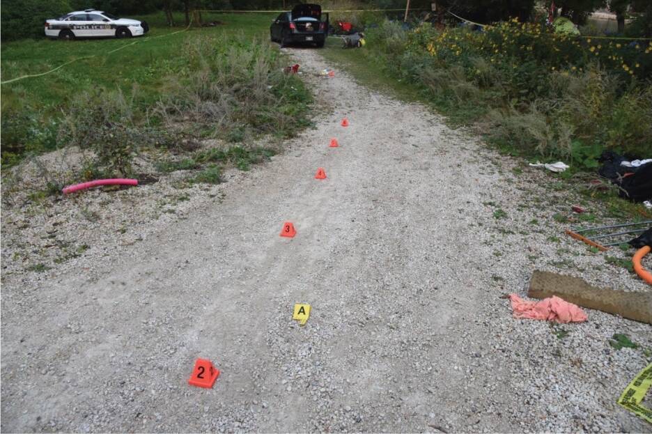 SUPPLIEDA photo in the IIU report shows evidence markers on the gravel road.