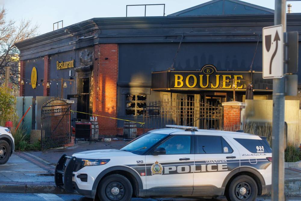 Winnipeg Fire Paramedic crews were dealing with the fire at the Boujee Restaurant & Bar, 191 Main St., on Thursday morning, and Winnipeg Police Service cadets directed traffic through the intersection. (Mike Deal / Free Press)