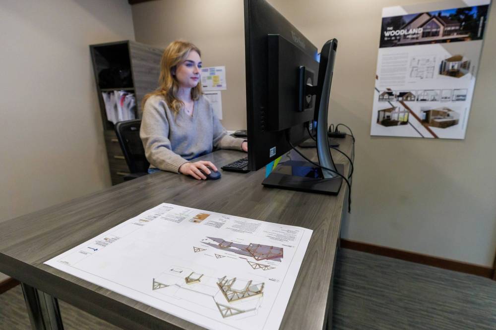 MIKE DEAL / FREE PRESS
Senior designer Kaite Preun works on a client plan.