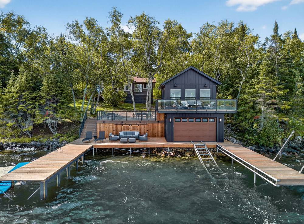 SUPPLIED
                                A boathouse built by Pine Creek Homes. The lower level offers 468 square feet of space with storage and access to the lake, complete with docks on either side for boat docking. Upstairs, the fully finished second floor provides 324 square feet of living space, extending out to a balcony with a view of the water. A large two-level deck connects it all.