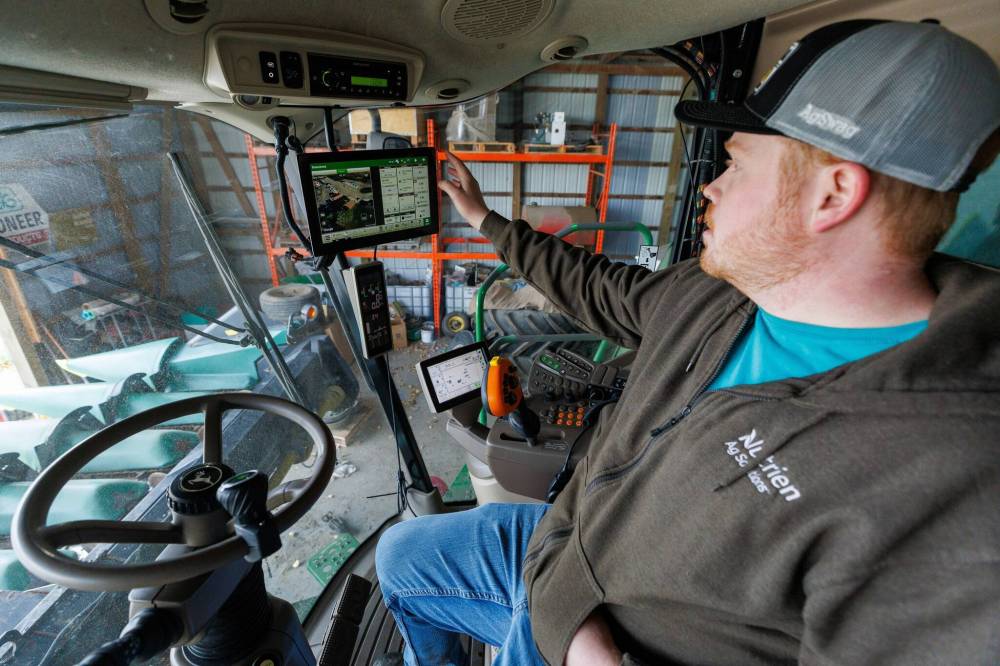 Jake Ayre is about two-thirds done harvesting, but needs Mother Nature’s help to tackle his corn. (Mike Deal / Free Press)