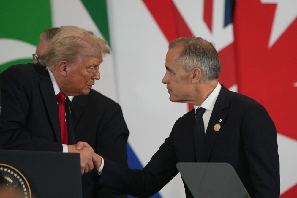 President Donald Trump, left, shares a moment with Prime Minister Mark Carney during a summit to support ending the Israel-Hamas war in Gaza on Monday, Oct. 13, 2025, in Sharm El Sheikh, Egypt. (AP Photo/Amr Nabil)