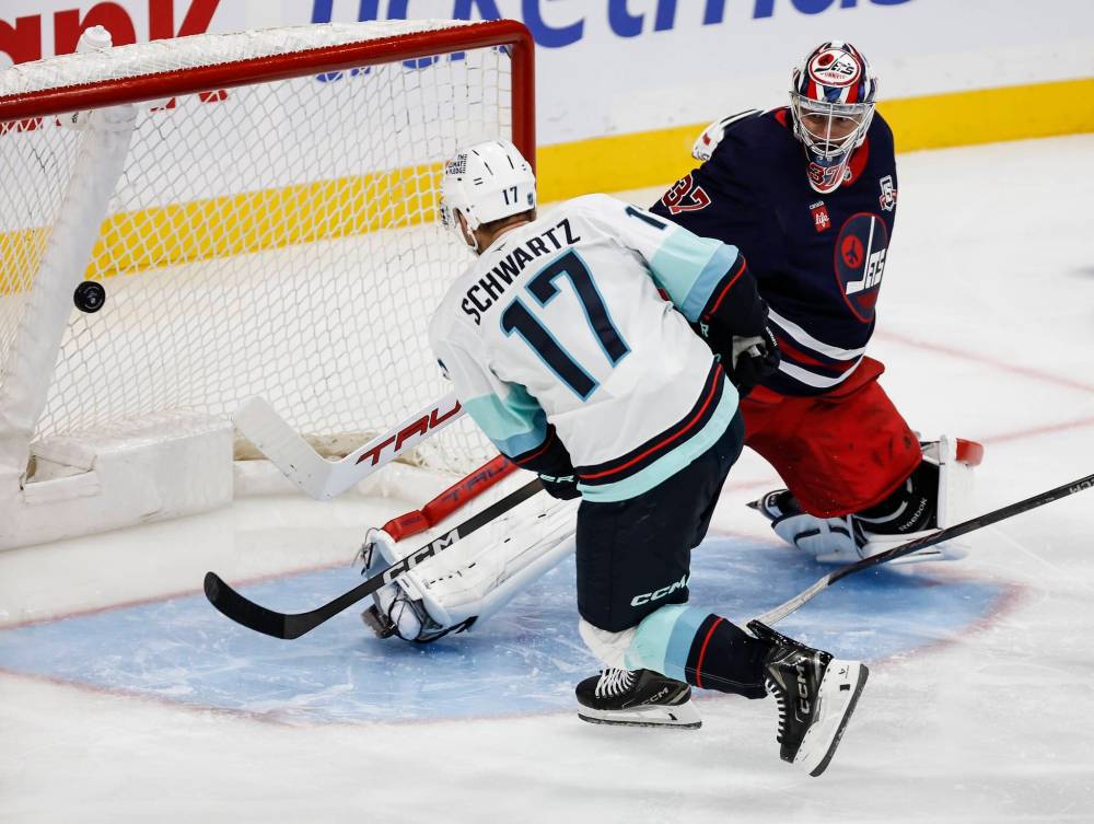 John Woods / THE CANADIAN PRESS
Seattle’s Jaden Schwartz scores the game-winning goal against Jets goalie Connor Hellebuyck on Thursday during the second period.