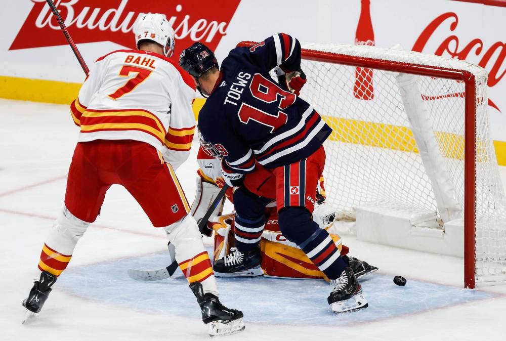 JOHN WOODS / THE CANADIAN PRESS
                                Jonathan Toews tapped the puck past Calgary goalie Dustin Wolf in the second period to score his first goal in his hometown as a member of the Winnipeg Jets.