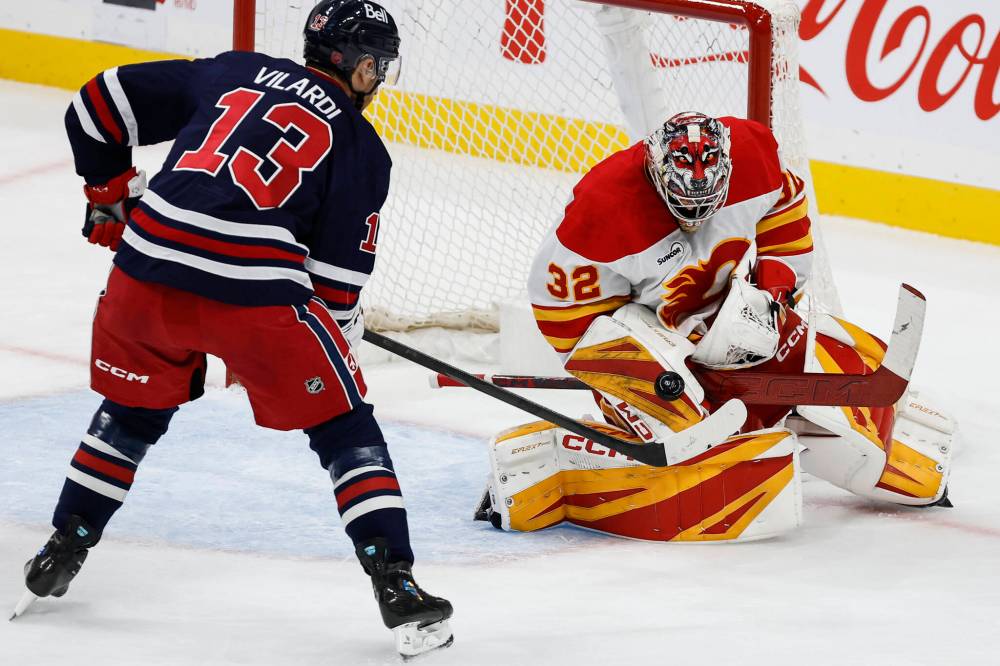 JOHN WOODS / THE CANADIAN PRESS
                                Calgary goaltender Dustin Wolf saves a shot from Gabriel Vilardi during the second period.