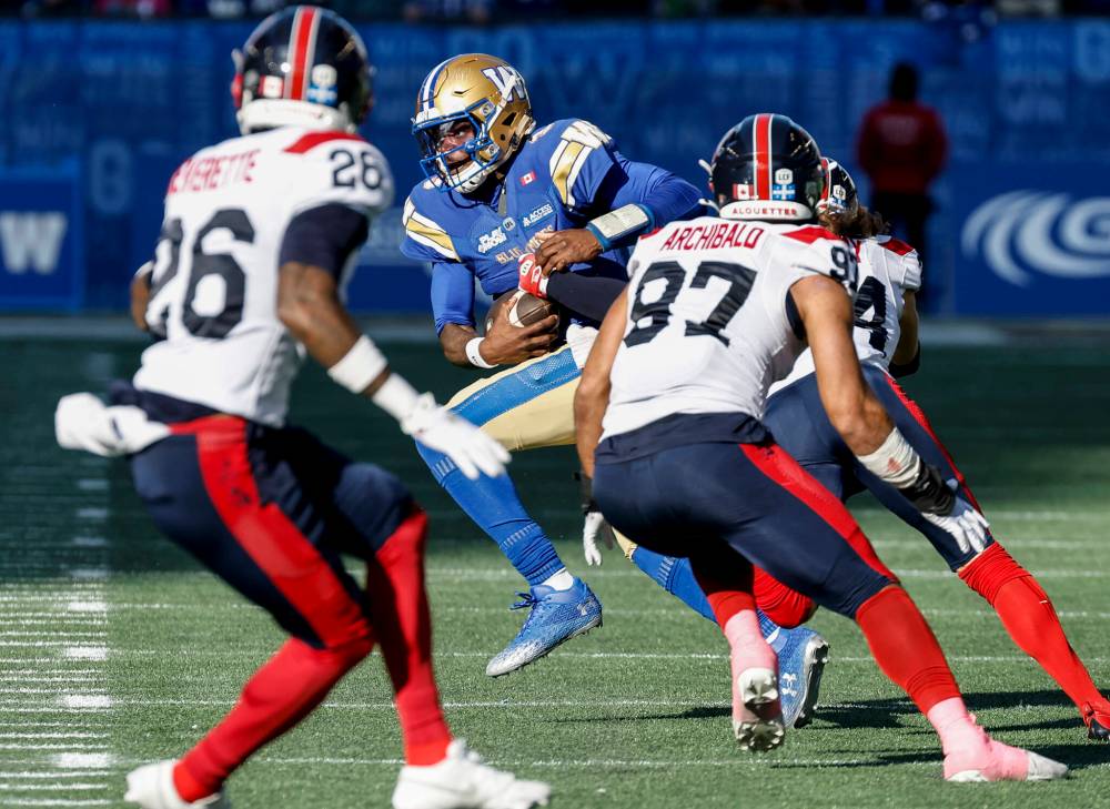JOHN WOODS / THE CANADIAN PRESS
Winnipeg Blue Bombers quarterback Terry Wilson (3) gets sacked by Montreal Alouettes’ Marc-Antoine Dequoy (24) during first half CFL action in Winnipeg, Saturday, Oct. 25, 2025.