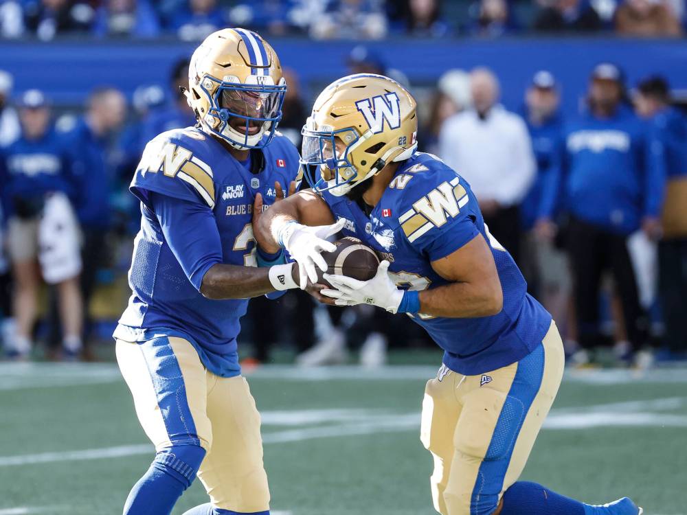 JOHN WOODS / THE CANADIAN PRESS
Winnipeg Blue Bombers quarterback Terry Wilson (3) hands off to Matthew Peterson (22) during first half CFL action against the Montreal Alouettes in Winnipeg, Saturday, Oct. 25, 2025.