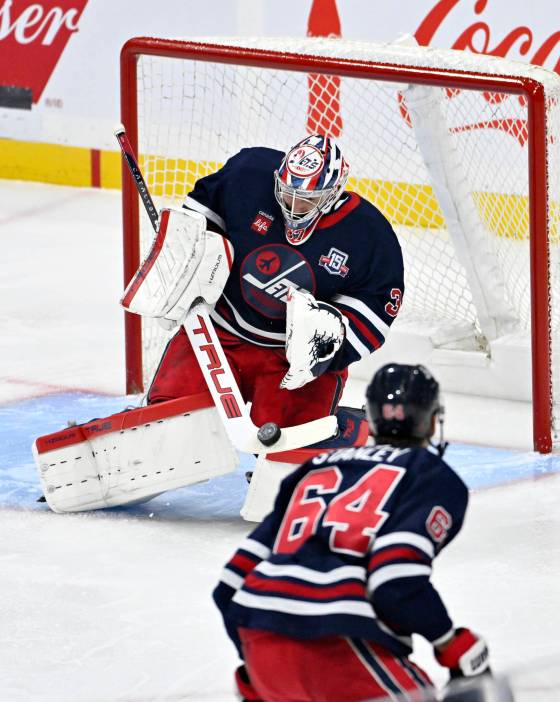 Winnipeg Jets goaltender Connor Hellebuyck (37) makes save on a Utah Mammoth shot during in Winnipeg on Sunday. (Fred Greenslade / The Canadian Press files)