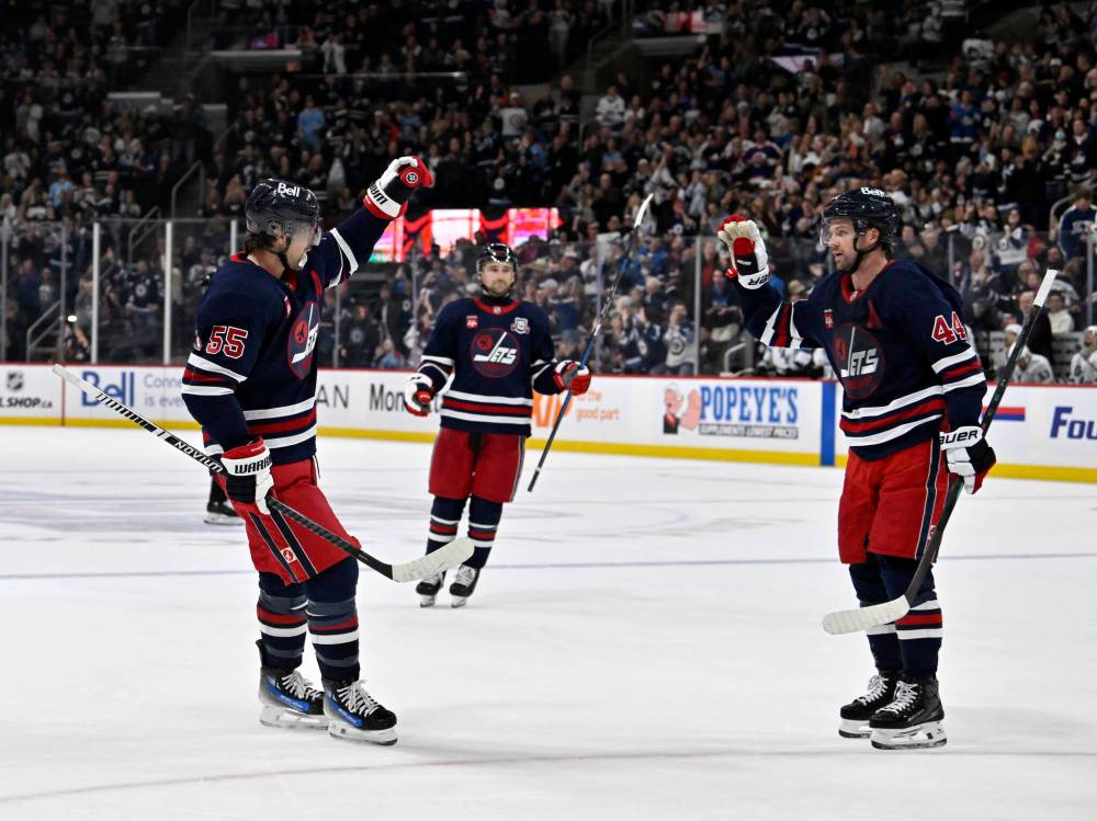 Fred Greenslade / The Canadian Press
                                Winnipeg Jets defencemen Josh Morrissey (right) and Neal Pionk (centre) celebrate Mark Scheifele's tying goal against the Utah Mammoth. Morrissey, who picked up two assists Sunday, said the goal every game is playing “a full 60 minutes of domination.”