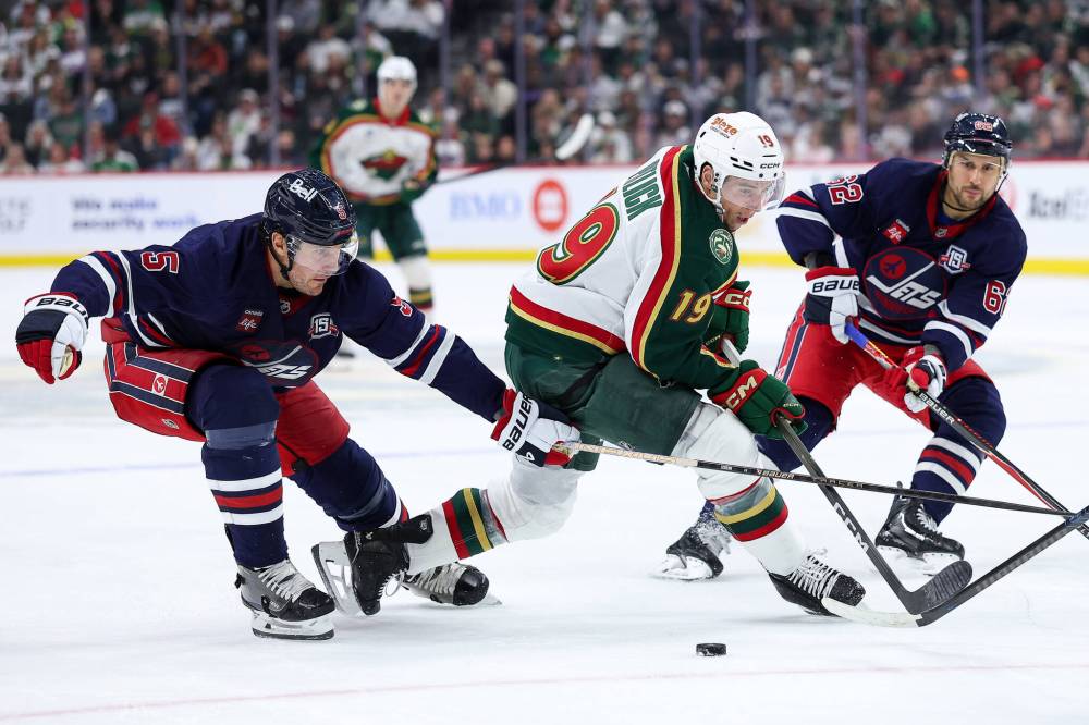 Matt Krohn / The Associated Press
                                Minnesota Wild forward Tyler Pitlick, middle, tries to stickhandle around Winnipeg Jets Luke Schenn and Nino Niederreiter in the third period.