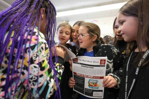 Ruth Bonneville / Free Press
                                Earl Grey School Students in Grades 4 and 5 in the literacy program look at photos inside the June 2025 edition of the Earl Grey Press Wednesday.