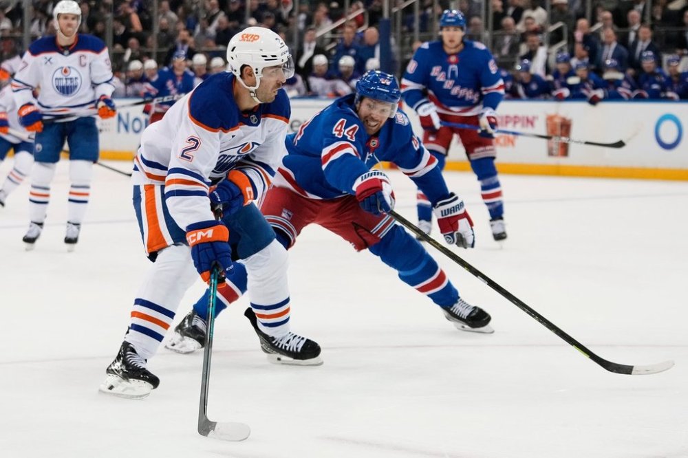 New York Rangers' Vladislav Gavrikov (44) defends Edmonton Oilers' Evan Bouchard (2) during the first period of an NHL hockey game Tuesday, Oct. 14, 2025, in New York. (AP Photo/Frank Franklin II)