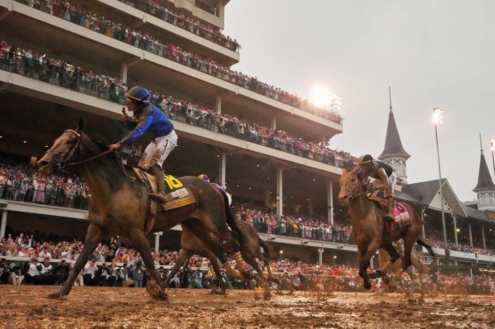 FILE - Sovereignty, ridden by Junior Alvarado, left, crosses the finish line to win the 151st running of the Kentucky Derby horse race followed by Journalism, ridden by Umberto Rispoli, Saturday, May 3, 2025, at Churchill Downs in Louisville, Ky. (AP Photo/Abbie Parr, File)