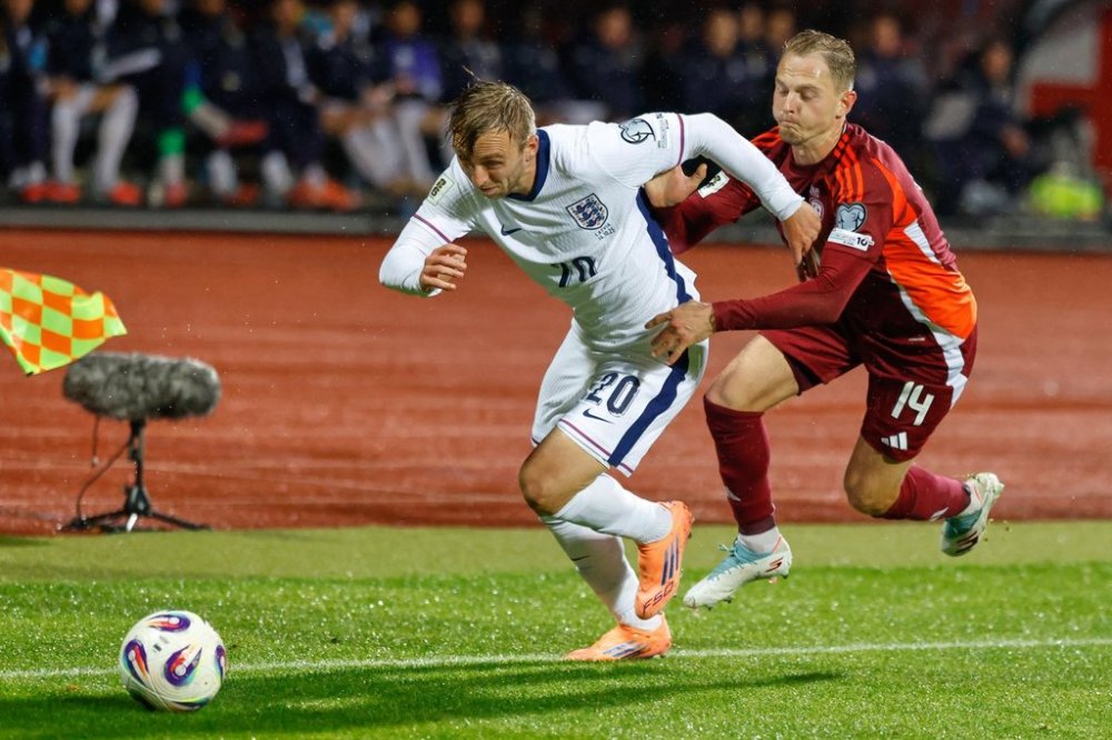 England's Jarrod Bowen tries to get away from Latvia's Andrejs Ciganiks during the 2026 World Cup group K qualifying soccer match between Latvia and England in Riga, Latvia, Tuesday, Oct. 14, 2025. (AP Photo/Mindaugas Kulbis)