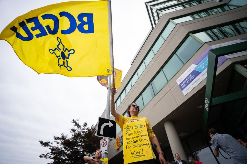 A member of the British Columbia General Employees' Union pickets outside an ICBC driver licensing office, in Surrey, B.C., Monday, Sept. 8, 2025. THE CANADIAN PRESS