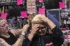 Stephanie LaBute tries on a Donald Trump style of wig, wth the help of Tori Larson at Theatre Garage in Edmonton on Friday, October 24, 2025.  THE CANADIAN PRESS/Amber Bracken
