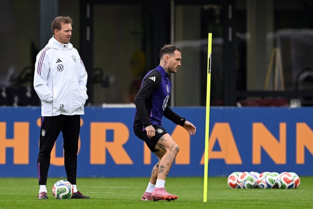Germany's head coach Julian Nagelsmann, left, and player david Raum attend a training session of the German national soccer team in Herzogenaurach, Germany, Tuesday, Oct. 7, 2025, ahead of the World Cup qualifier soccer match against Luxembourg. (Federico Gambarini/dpa via AP)
