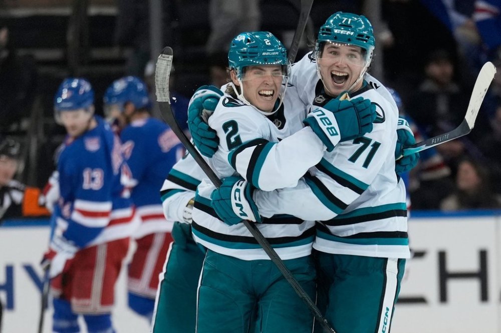 San Jose Sharks' Will Smith, left, celebrates his winning goal with Macklin Celebrini at the end of the overtime period of an NHL hockey game in New York, Thursday, Oct. 23, 2025. (AP Photo/Seth Wenig)
