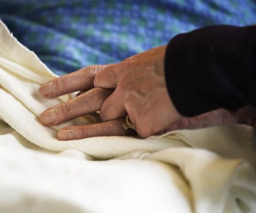 A patient has his hand held at a hospital, in Minneapolis, Monday, May 3, 2021. THE CANADIAN PRESS/AP-David Joles, Star Tribune, *MANDATORY CREDIT*