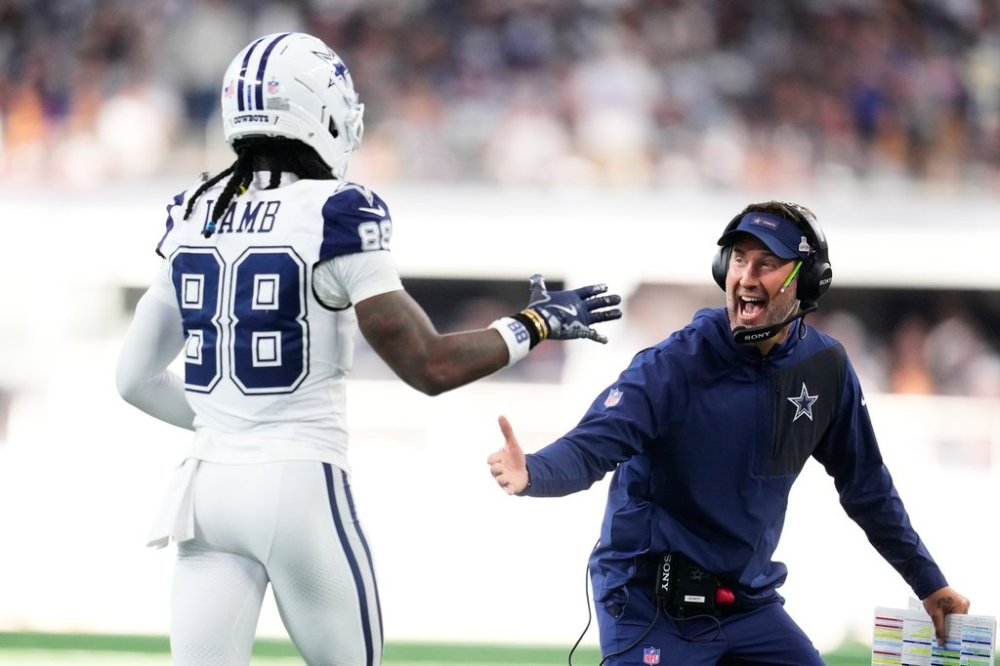 Dallas Cowboys head coach Brian Schottenheimer, right, greets wide receiver Ceedee Lamb (88) near the bench after a touchdown against the Washington Commanders during the second half of an NFL football game Sunday, Oct. 19, 2025, in Arlington, Texas. (AP Photo/Jeffrey McWhorter)