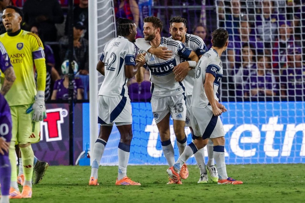 Vancouver Whitecaps forward Thomas Müller (13) celebrate with teammates forward Nelson Pierre (42), defender Belal Halbouni, right center, and midfielder Sebastian Berhalter, right, after he scored the second goal against Orlando City during the second half of an MLS soccer match, Saturday, Oct. 11, 2025, in Orlando, Fla. (AP Photo/Kevin Kolczynski)