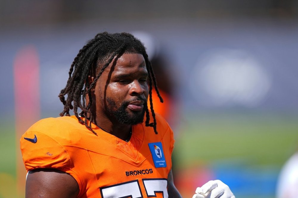 FILE - Denver Broncos linebacker Dre Greenlaw (57) warms up at an NFL football training practice July 28, 2025, in Centennial, Colo. (AP Photo/David Zalubowski, File)