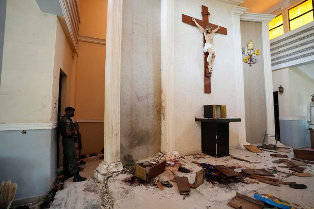 FILE - A police officer stands guard inside the St. Francis Catholic Church, a day after an attacked that targeted worshipers in Owo, Nigeria, June. 6, 2022. (AP Photo/Sunday Alamba, File)