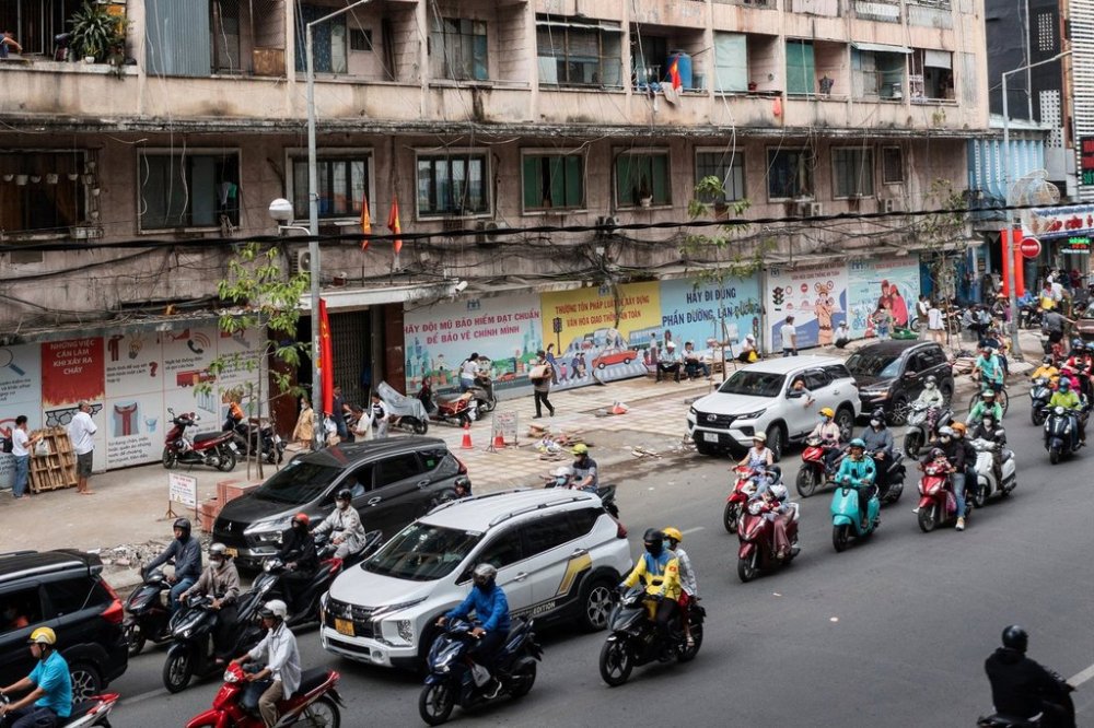 FILE - Motorbikes and cars pass by a building that was once the Victoria Hotel in Ho Chi Minh City, Vietnam, April 18, 2025. (AP Photo/Thanh Hue, File)