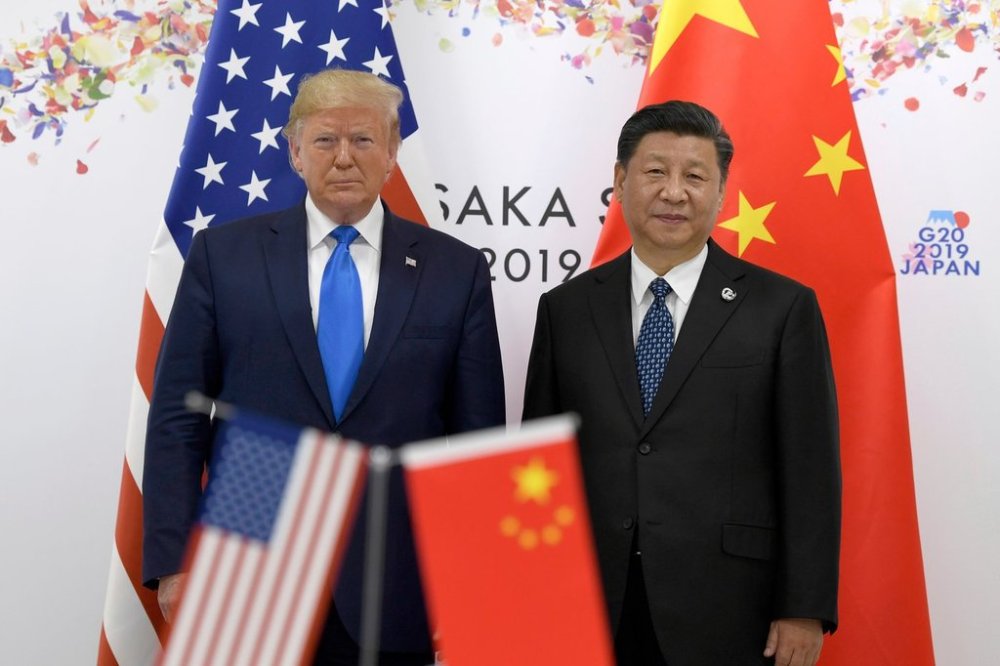 FILE - President Donald Trump, left, poses for a photo with Chinese President Xi Jinping during a meeting on the sidelines of the G-20 summit in Osaka, Japan, June 29, 2019. (AP Photo/Susan Walsh, File)