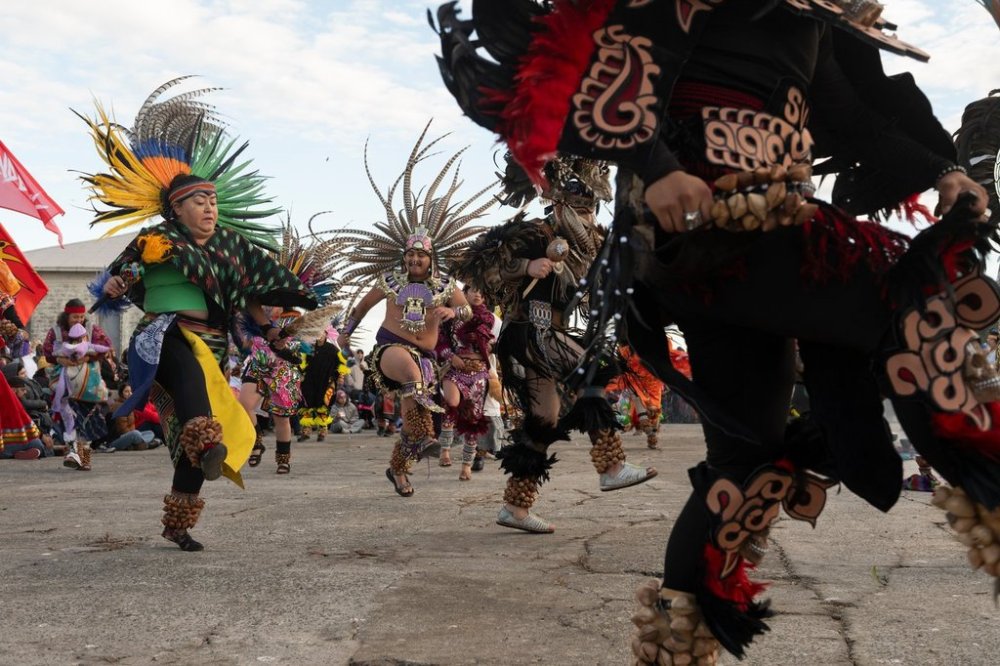 Aztec dancers perform during a sunrise gathering on Indigenous Peoples Day on Alcatraz Island on Monday, Oct. 13, 2025, in San Francisco. (AP Photo/Laure Andrillon)
