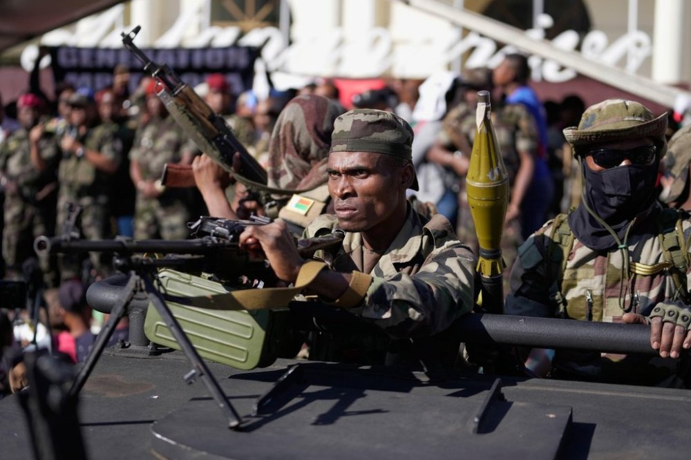 Troops loyal to CAPSAT military unit commander Col. Michael Randrianirina joins protesters to announce that the armed forces are taking control of the country in Antananarivo, Madagascar, Tuesday, Oct. 14, 2025. (AP Photo/Brian Inganga)