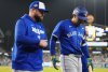 Toronto Blue Jays' George Springer (4) walks off the field as he leaves the game with an injury with manager John Schneider during seventh inning Game 3 World Series playoff MLB baseball action in Los Angeles on Monday, Oct. 27, 2025. THE CANADIAN PRESS/Frank Gunn