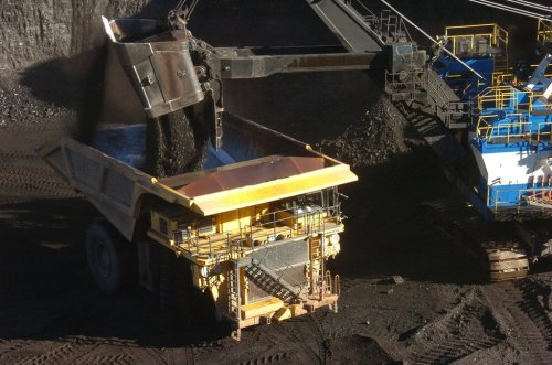 FILE - A mechanized shovel loads coal into a haul truck at a mine near Decker, Mont., on Nov. 15, 2016. (AP Photo/Matthew Brown, File)