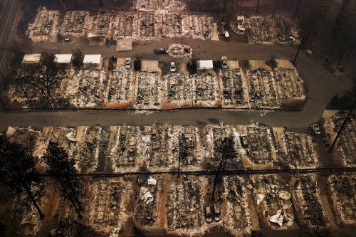 FILE - The remains of homes leveled by the Camp wildfire, appear in Paradise, Calif., on Nov. 15, 2018. (AP Photo/Noah Berger, File)