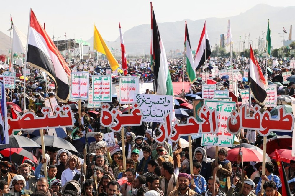 Houthi supporters celebrate following the announcement that Israel and Hamas have agreed to the first phase of a peace plan to pause the fighting, in Sanaa, Yemen, Friday, Oct. 10, 2025. Arabic reads,