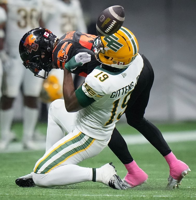 Edmonton Elks' Kurleigh Gittens Jr., front is unable to hold onto the ball on a reception as he's hit by B.C. Lions' Robert Carter Jr. during the second half of a CFL football game, in Vancouver, on Friday, Oct. 17, 2025. THE CANADIAN PRESS/Darryl Dyck