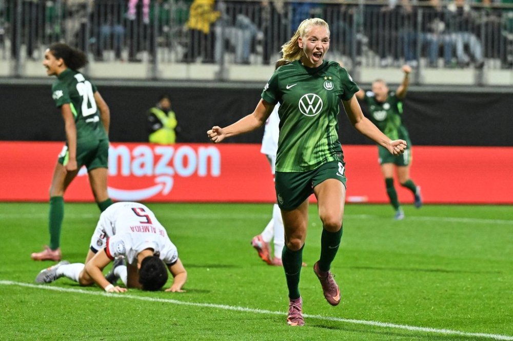 VfL Wolfsburg's Ella Peddemors celebrates after scoring their second goal against Paris St. Germain during a Women's Champions League soccer match, Wednesday, Oct. 8, 2025, in Wolfsburg, Germany. (Swen Pförtner/dpa via AP)