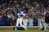 Chicago Cubs' Ian Happ (8) hits a 3-run home run during the first inning of Game 4 of baseball's National League Division Series against the Milwaukee Brewers Thursday, Oct. 9, 2025, in Chicago. (AP Photo/Nam Y. Huh)