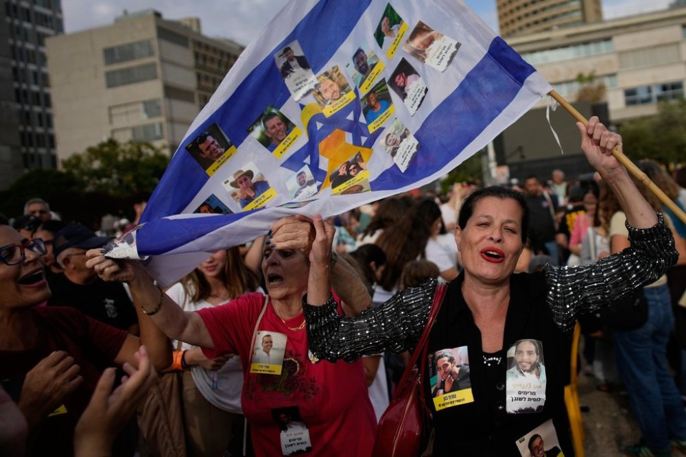 People react as they celebrate following the announcement that Israel and Hamas have agreed to the first phase of a peace plan to pause the fighting, at a plaza known as Hostages Square in Tel Aviv, Israel, Thursday, Oct. 9, 2025. THE CANADIAN PRESS/AP-Ohad Zwigenberg