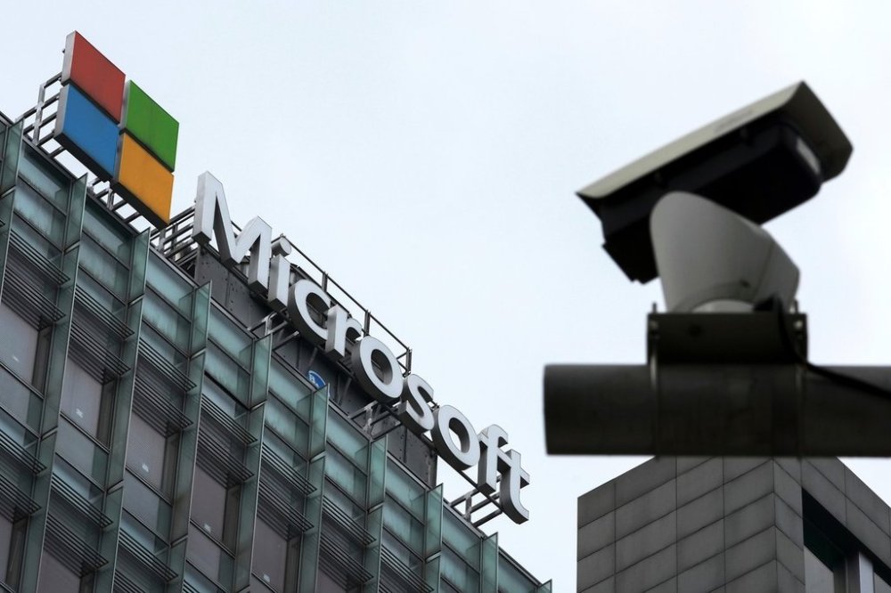 FILE - A security surveillance camera is seen near the Microsoft office building in Beijing, July 20, 2021. (AP Photo/Andy Wong, File)