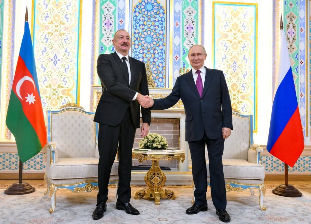 Russian President Vladimir Putin, right, and Azerbaijan's President Ilham Aliyev shake hands prior to their talks on the sidelines of the Russia-Central Asia summit in Dushanbe, Tajikistan, on Thursday, Oct. 9, 2025. (Grigory Sysoyev, Sputnik, Kremlin Pool Photo via AP)