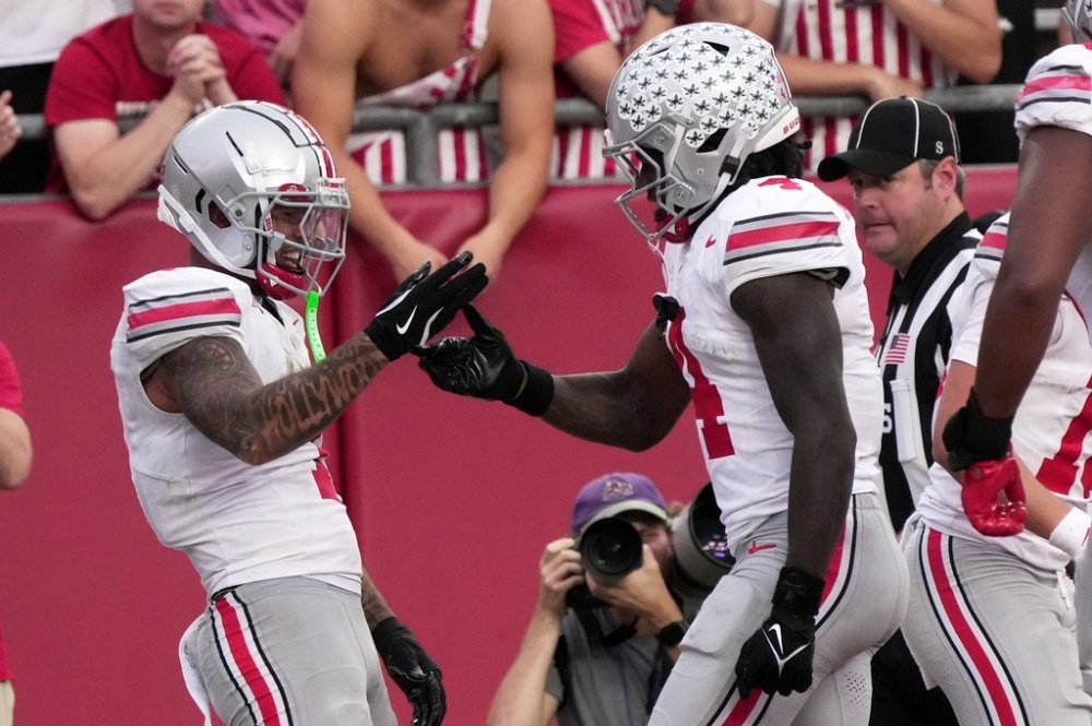 Ohio State's Brandon Inniss celebrates his touchdown catch with Jeremiah Smith during the second half of an NCAA college football game against the Wisconsin Saturday, Oct. 18, 2025, in Madison, Wis. (AP Photo/Morry Gash)