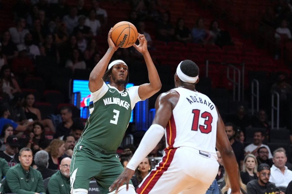 Milwaukee Bucks forward Myles Turner (3) looks for an opening past Miami Heat center Bam Adebayo (13) during the first half of a preseason NBA basketball game, Monday, Oct. 6, 2025, in Miami. (AP Photo/Rebecca Blackwell)