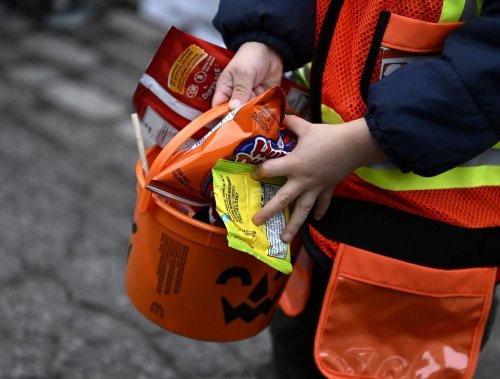 A child's bucket is full of candy as they go trick-or-treating at Rideau Hall on Halloween in Ottawa on Monday, Oct. 31, 2022. THE CANADIAN PRESS/Justin Tang