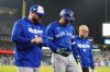 Toronto Blue Jays slugger George Springer (4) walks off the field with manager John Schneider, left, and trainer Voon Chong during the seventh inning of Game 3 of the World Series in Los Angeles on Oct. 27, 2025. THE CANADIAN PRESS/Frank Gunn