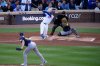 Chicago Cubs' Michael Busch hirts a home run during the first inning of Game 3 of baseball's National League Division Series against the Milwaukee Brewers Wednesday, Oct. 8, 2025, in Chicago. (AP Photo/Nam Huh)